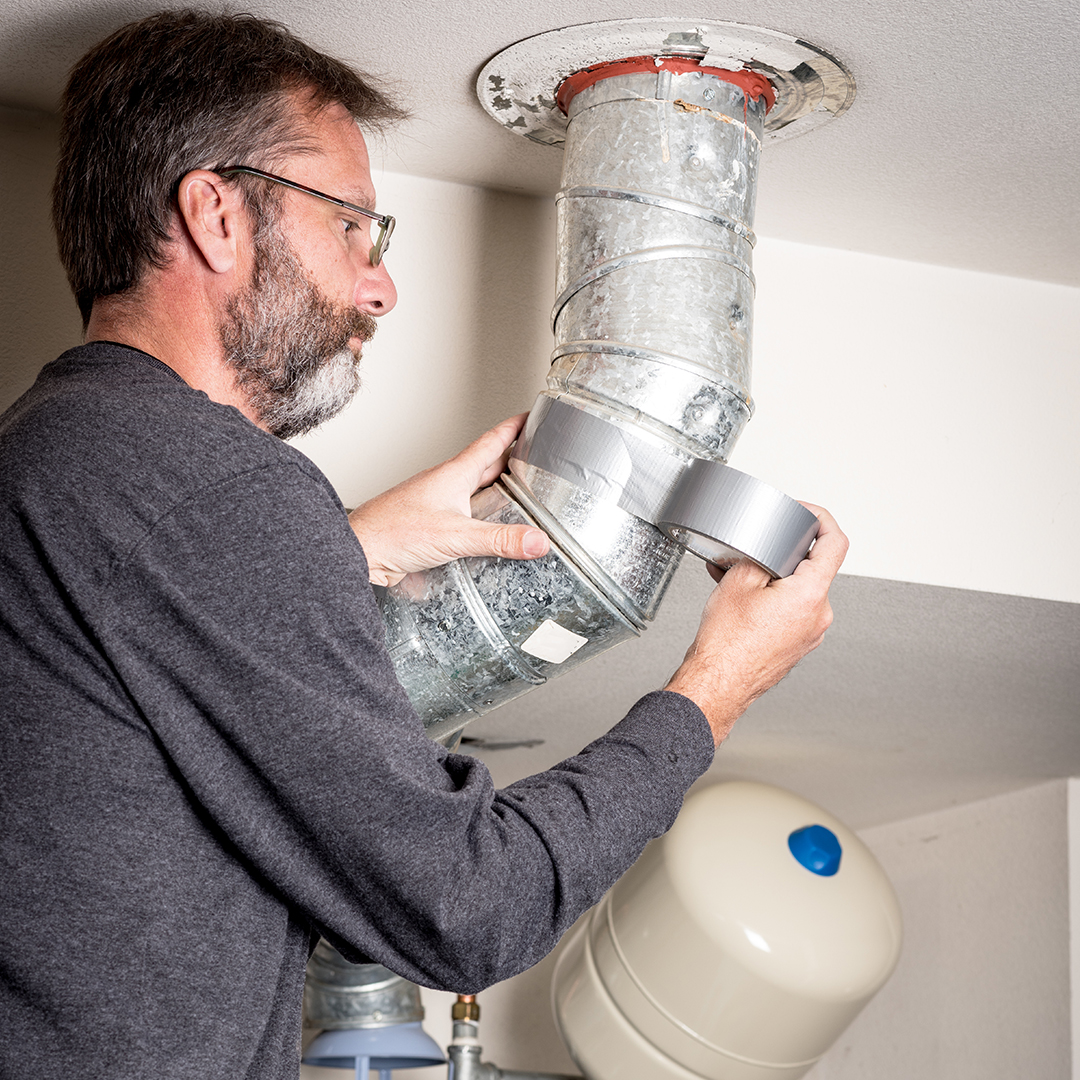 man working on an air duct