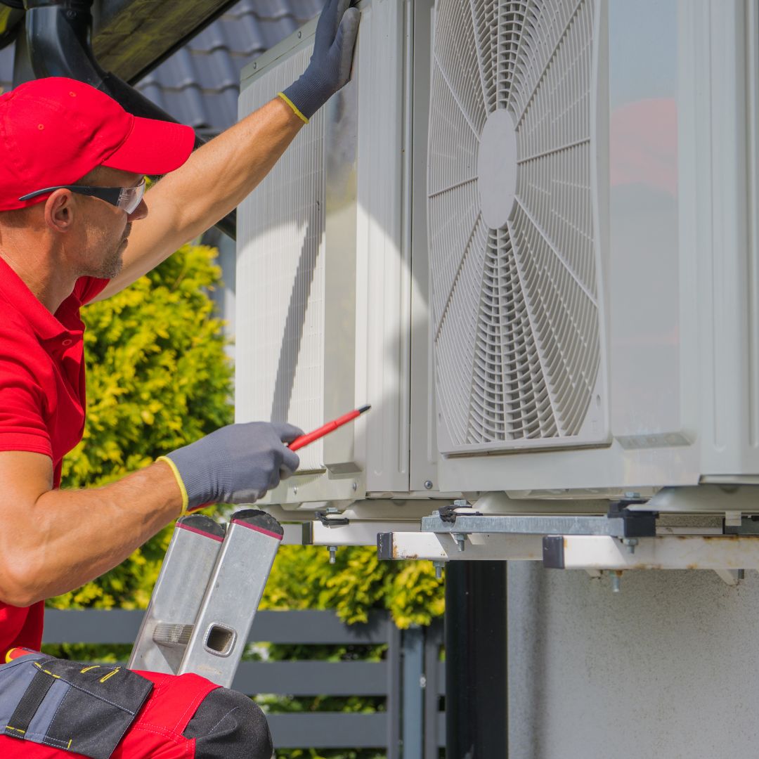 Repair man working on air conditioning unit